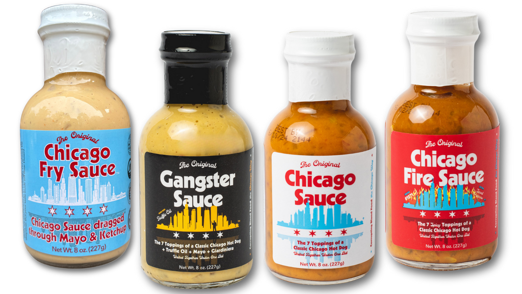 Four glass bottles of Chicago sauce products lined up on a white background: Chicago Fry Sauce with a blue label, Gangster Sauce with a black label, Chicago Sauce with a white label, and Chicago Fire Sauce with a red label.